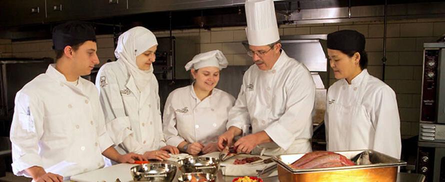 Students learning from a chef